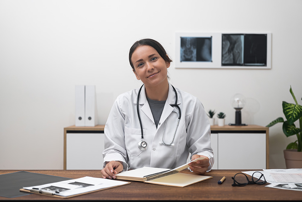 Female doctor at her desk talking about local SEO for doctors