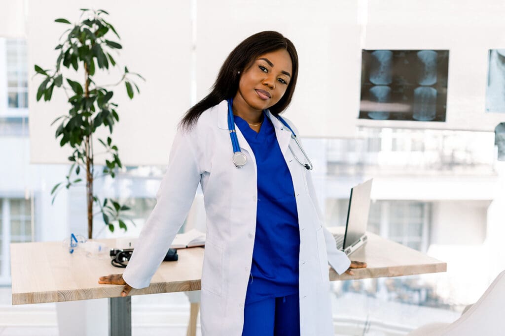 Female doctor standing by her desk talking about healthcare digital marketing